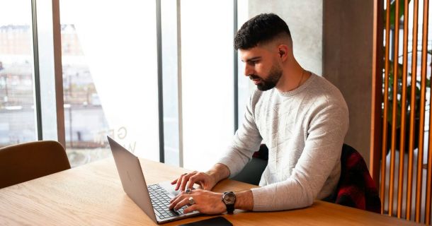 Image of a property manager using a laptop device