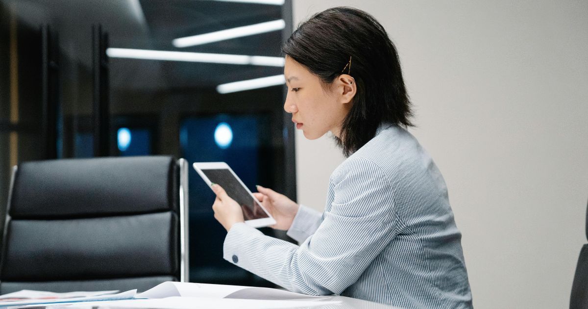 Professional using tablet indoors to manage facility management software