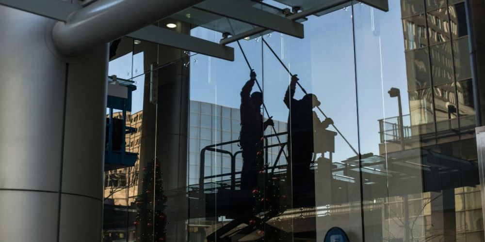 image of maintenance workers outside a building exterior